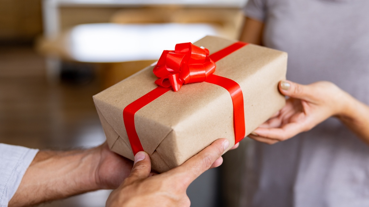 Close-up on a person giving an gift via Getty Images, Hispanolistic