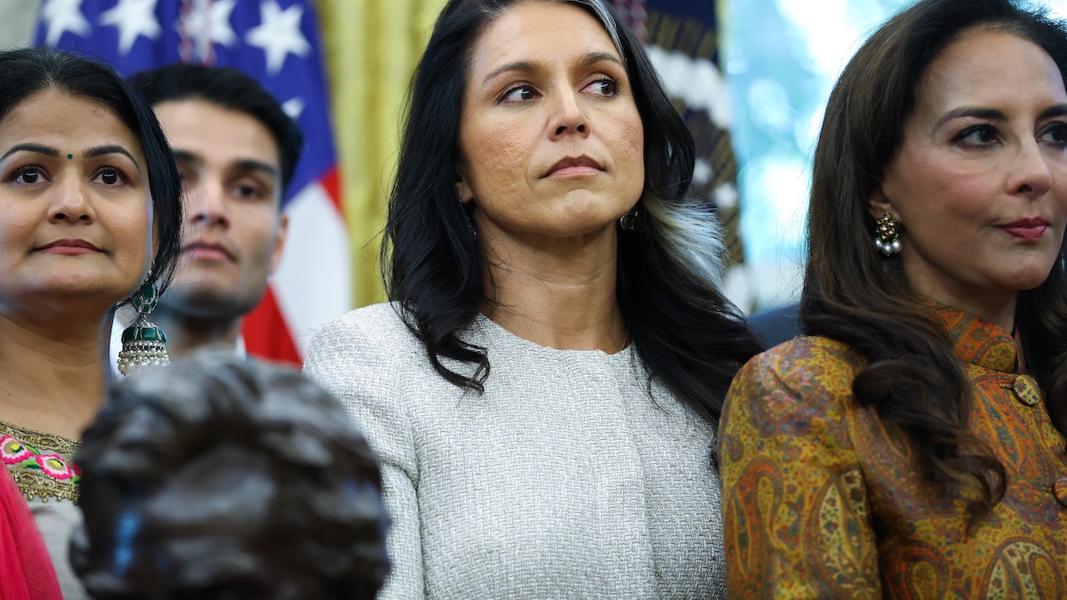 WASHINGTON, DC - OCTOBER 21: Director of National Intelligence Tulsi Gabbard (C) listens as U.S. President Donald Trump delivers remarks during an event celebrating Diwali in the Oval Office of the White House on October 21, 2025 in Washington, DC. Trump held the event to honor the Hindu festival that symbolizes the victory of light over darkness.