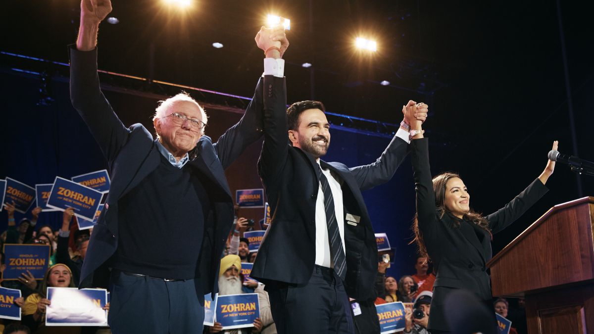 New York Mayoral Candidate Zohran Mamdani, center, celebrates with Sen. Bernie Sanders (I-VT), left, and U.S. Rep. Alexandria Ocasio-Cortez (D-NY), right, during an election rally on October 26, 2025 at Forest Hills Stadium in the Queens borough of New York City. The mayoral election will take place on November 4, 2025. (Photo by Andres Kudacki/Getty Images)