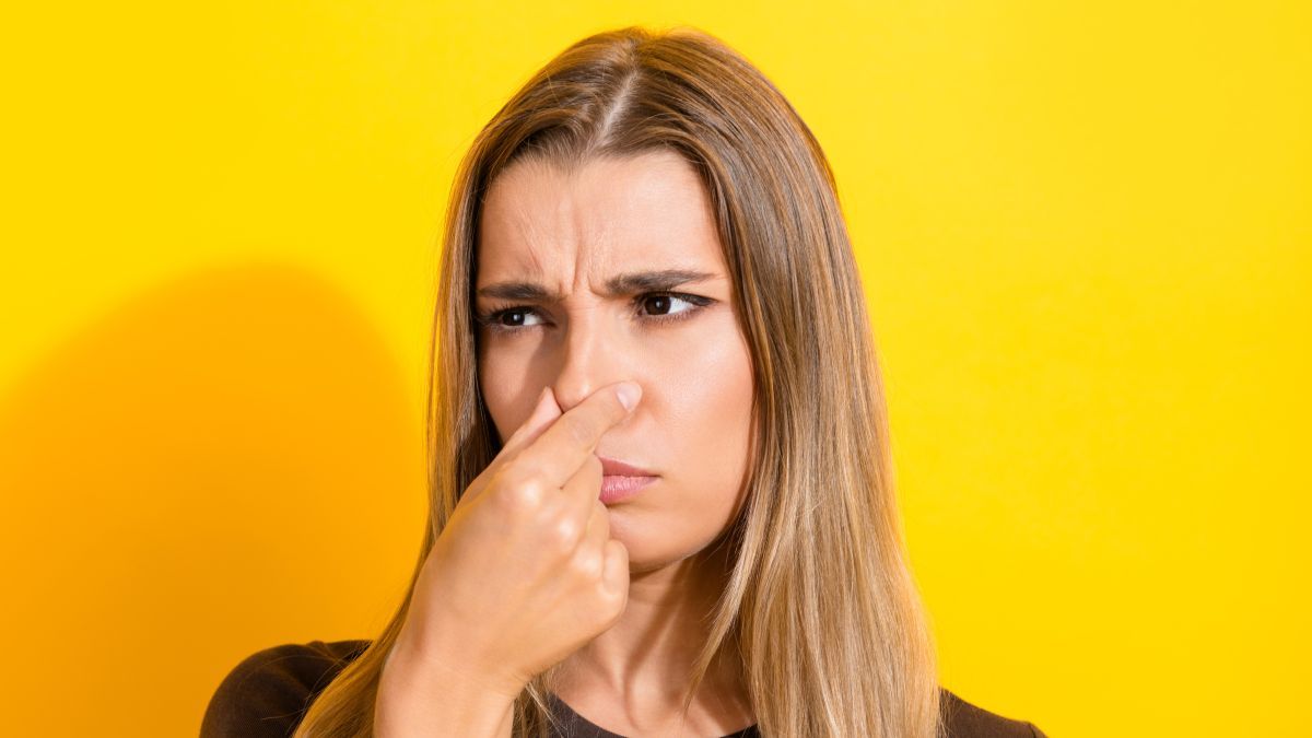 Woman smelling something bad