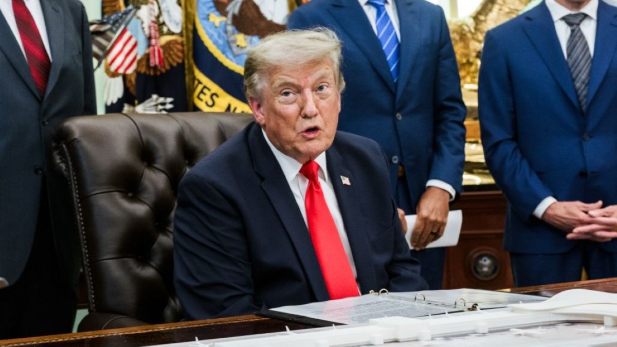 Donald Trump sitting in the Oval Office