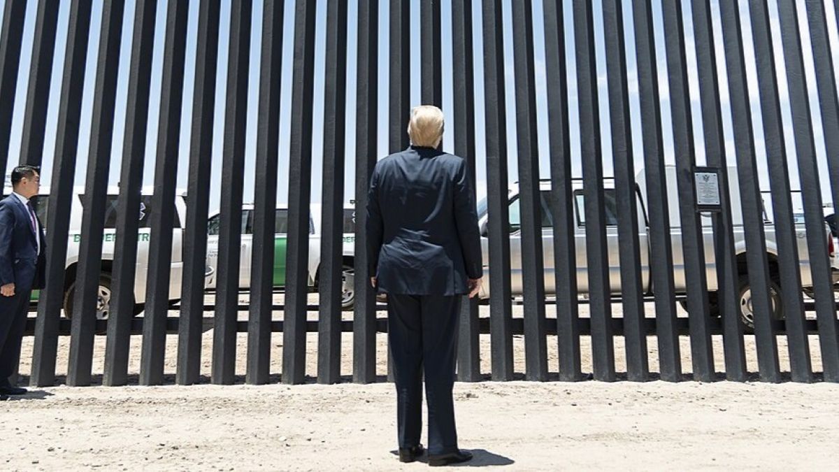 President Donald Trump with a section of the border wall near Yuma, Arizona, June 2020