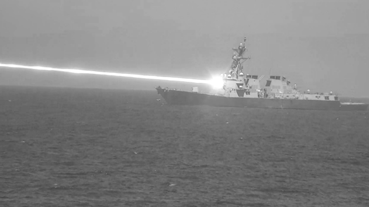 A US Navy ship firing a laser weapon
