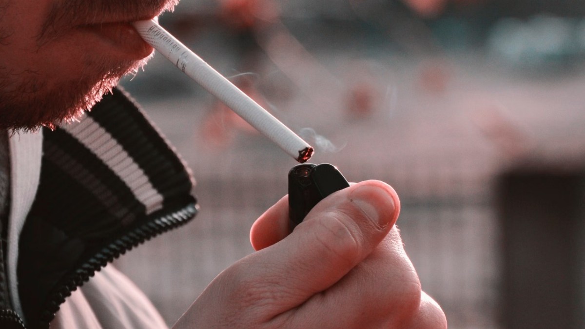 A man lighting a cigarette