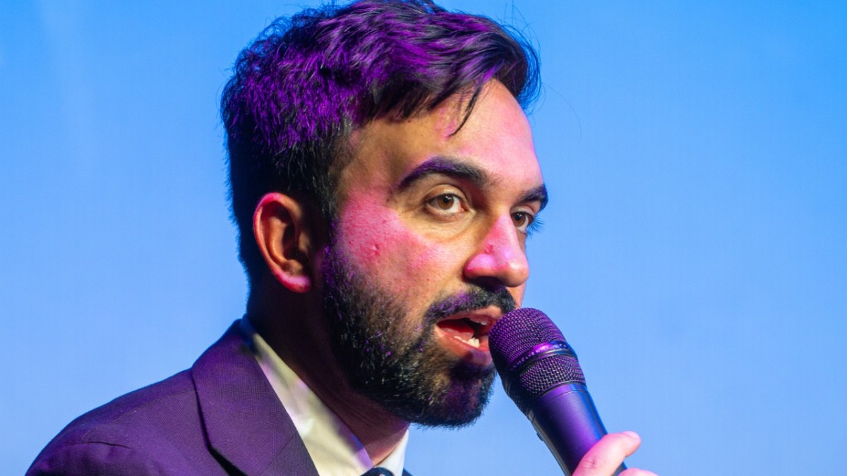 Zohran Mamdani speaking on the microphone.